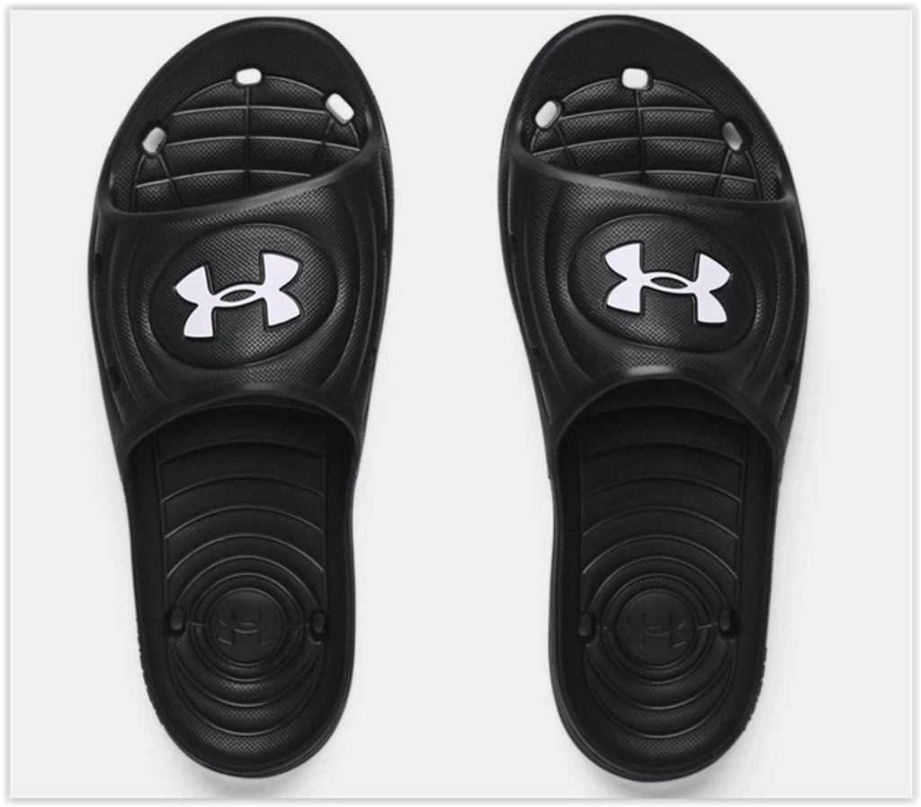 A pair of black Under Armour slides shown from a top-down view against a white background.