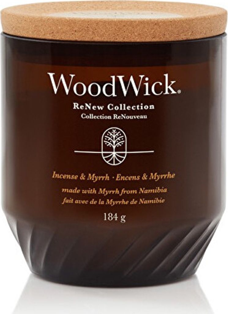 A close-up studio shot of a WoodWick candle in a brown glass jar with a cork lid.