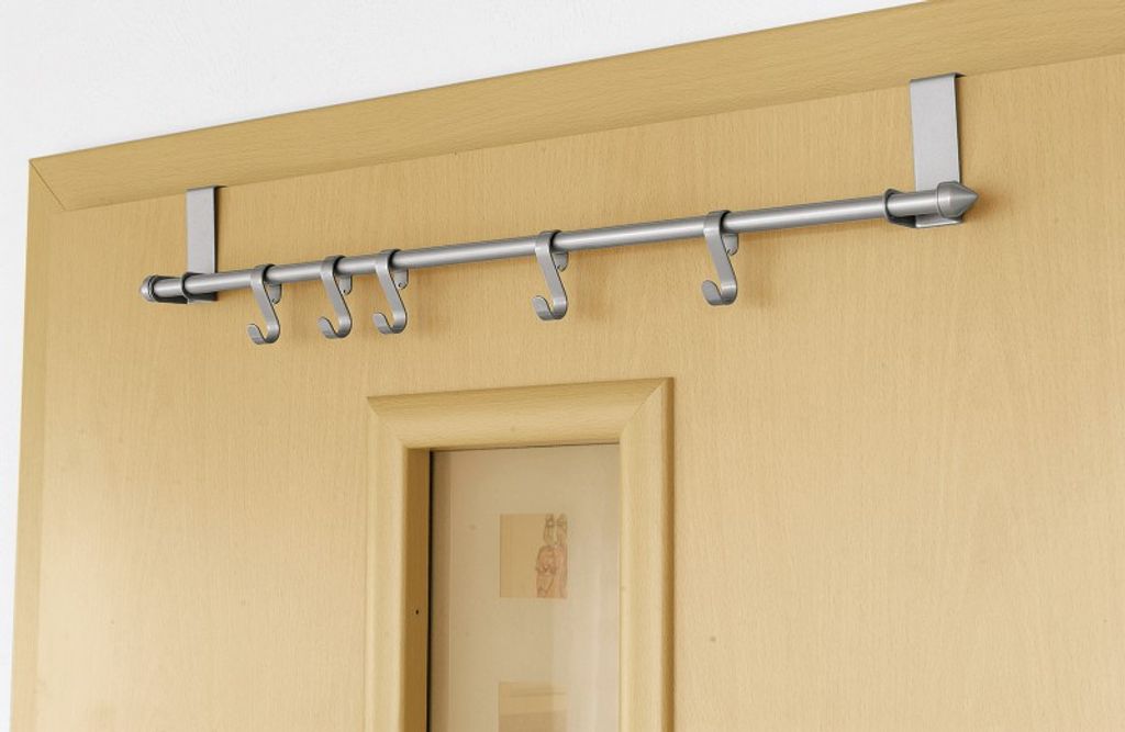 An over-the-door hook rack mounted on a wooden door.