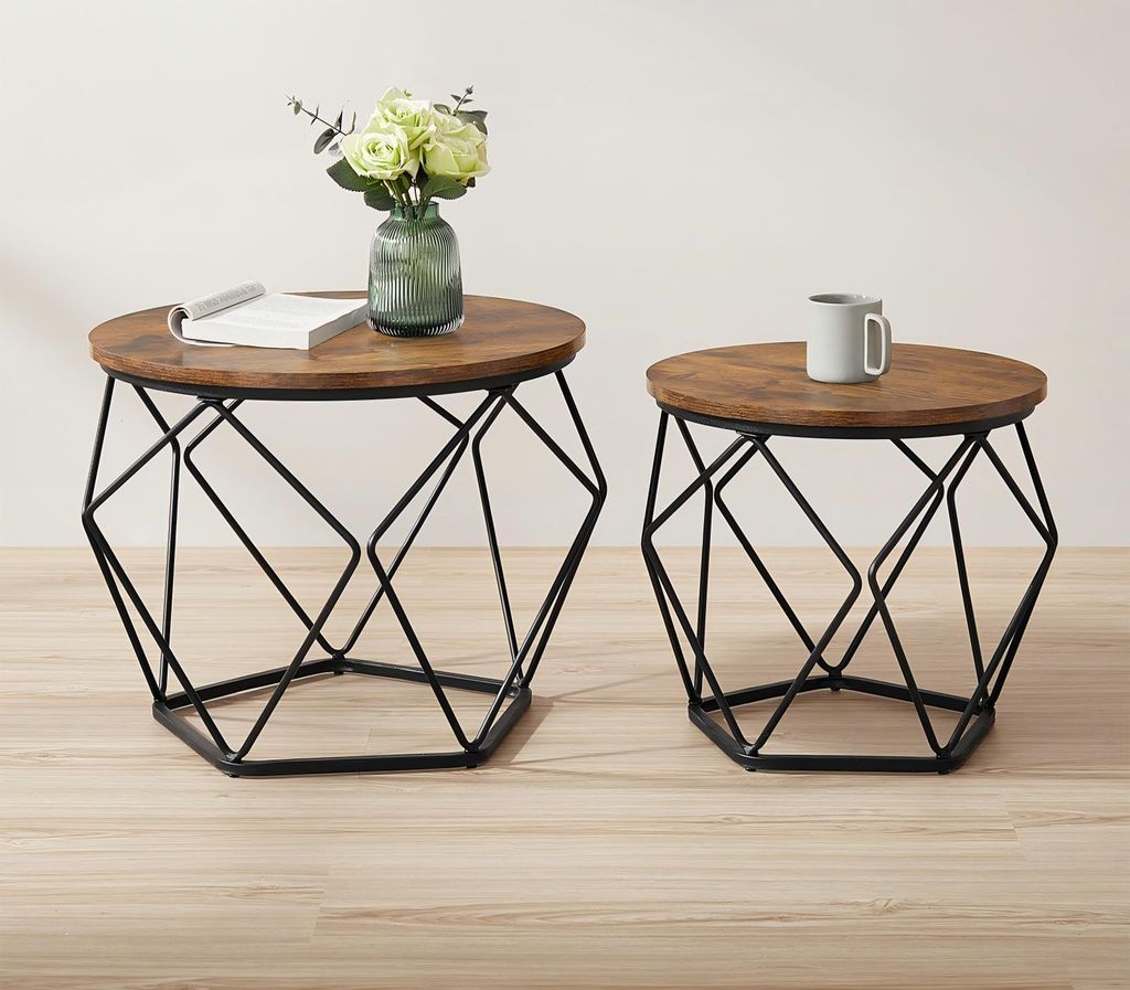Two round side tables with wooden tops and geometric black metal bases are shown against a plain background.