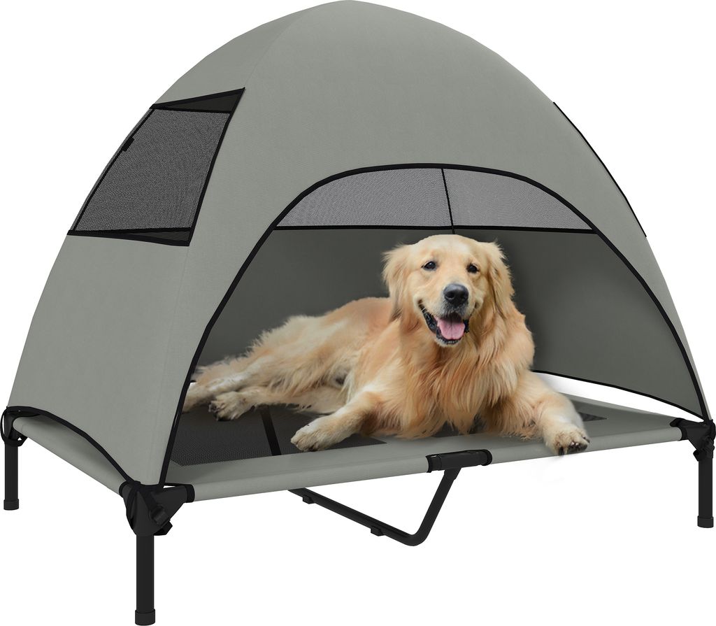 A golden retriever dog is lying on an elevated pet bed with a canopy.