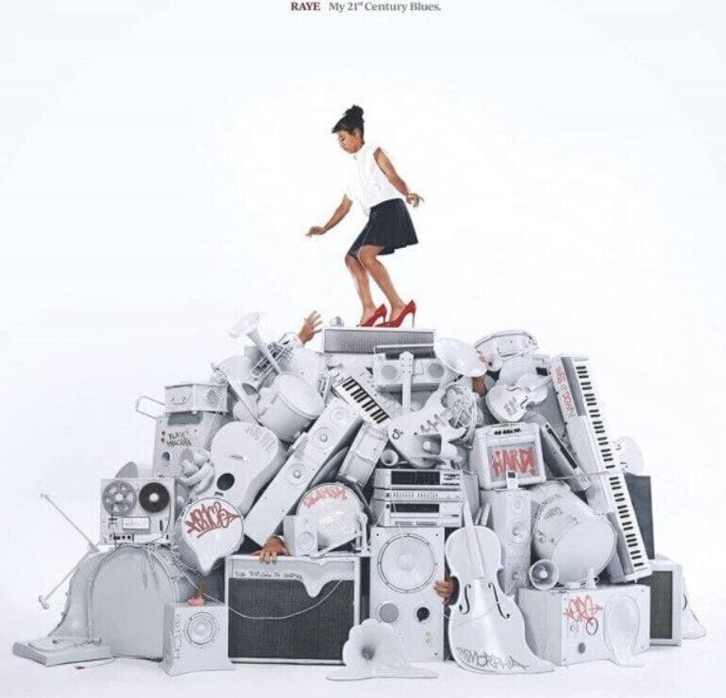 A woman stands on a pile of musical instruments, reaching upwards.