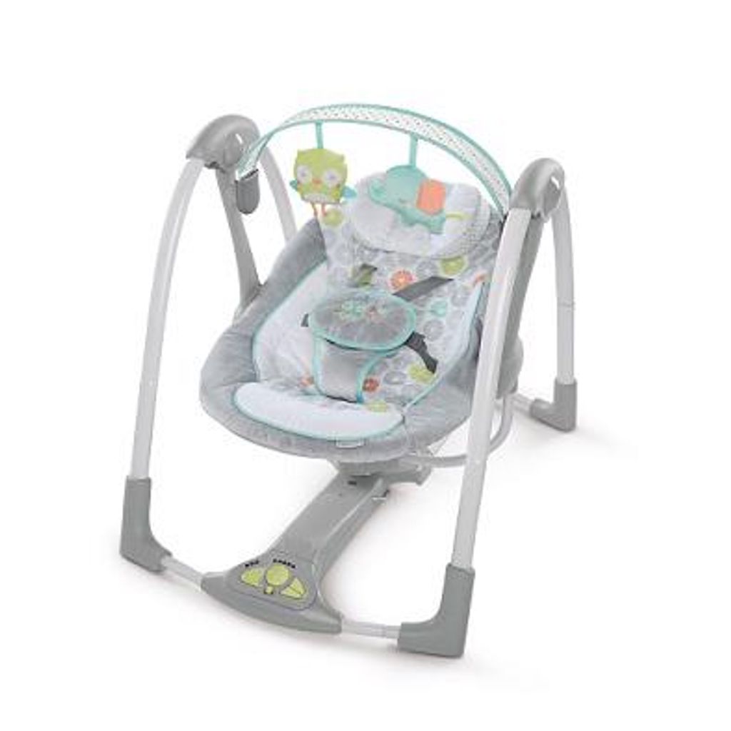 A baby swing with toys hanging from the top.