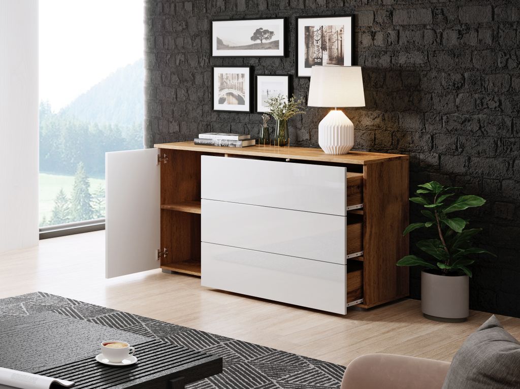 A modern dresser with a white front and wood-grain sides is shown in a living room setting.