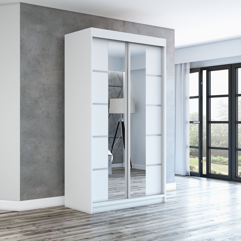 A white sliding door wardrobe with mirrored panels stands in a room with a gray concrete wall and wooden floor.