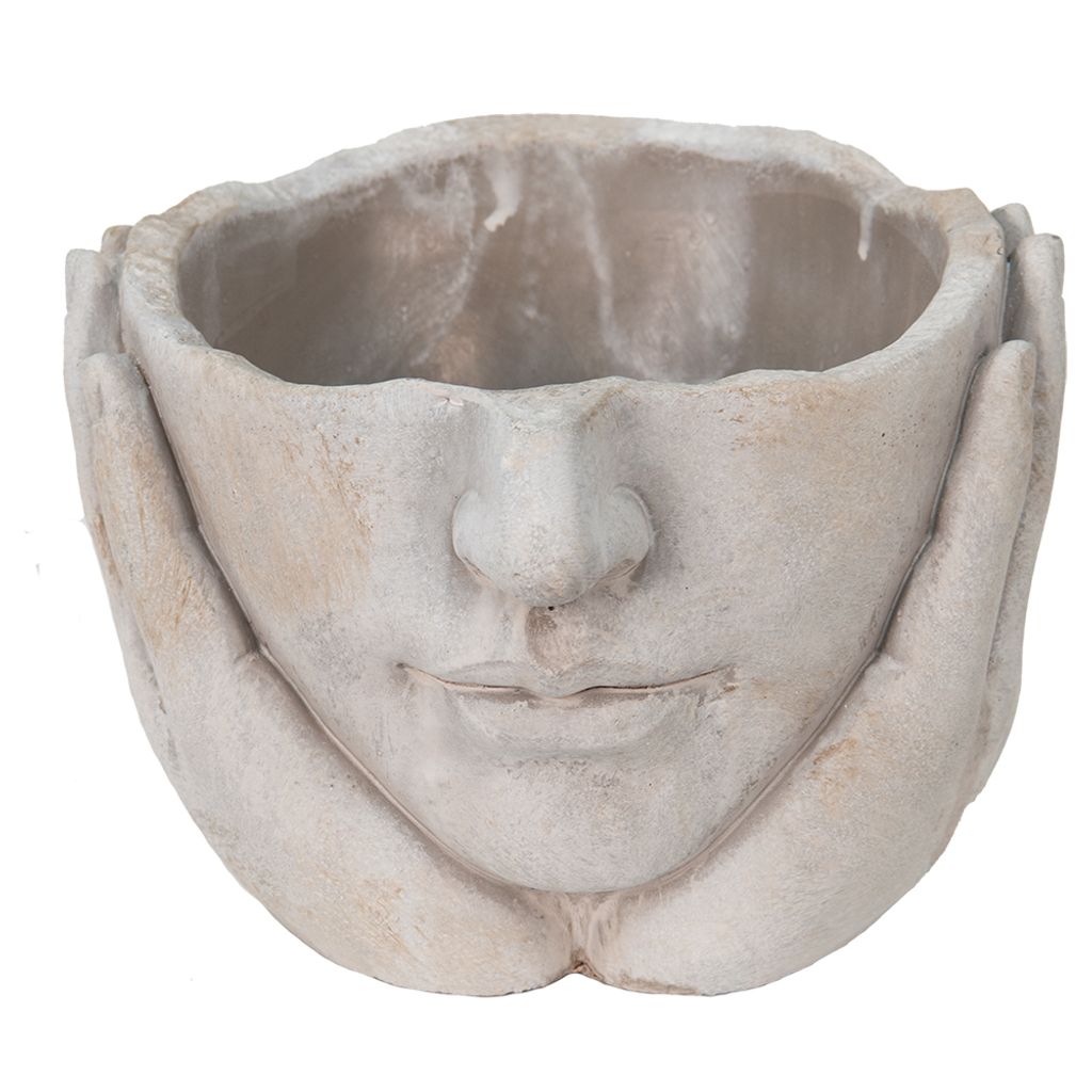 A close-up, front-facing view of a decorative planter shaped like a face with hands supporting the head.