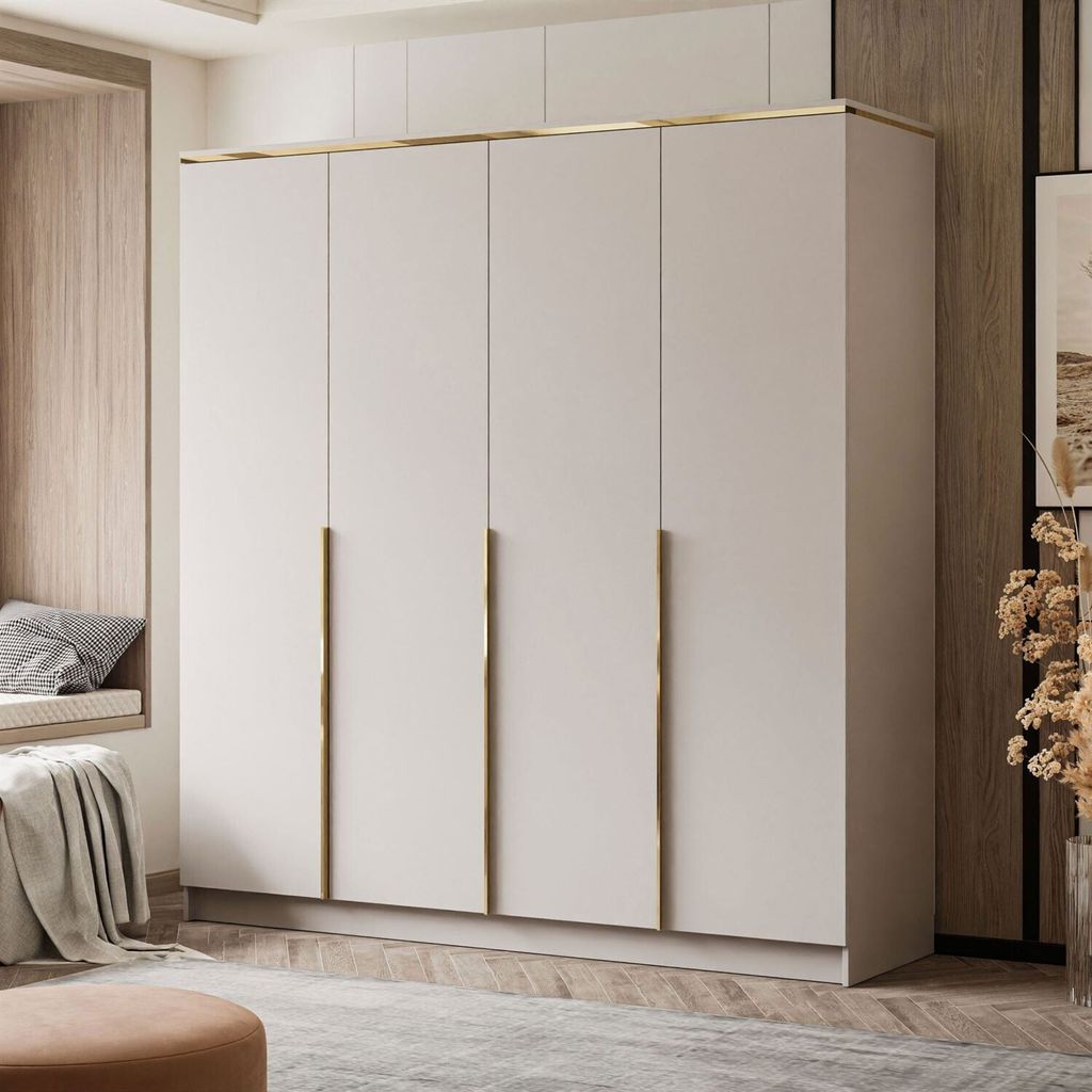 A modern wardrobe with four doors and gold handles in a room with a window seat.