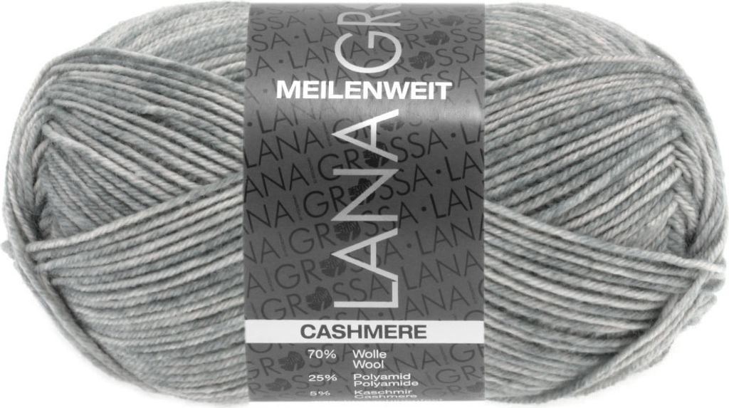 A ball of grey and white variegated yarn with a label.