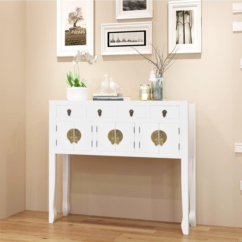 A white Chinese-style sideboard with gold hardware is displayed against a light beige wall, with framed artwork above it.