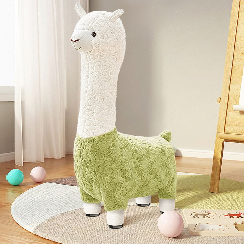 A plush alpaca stool is placed on a rug in a child's room, with toys scattered around.