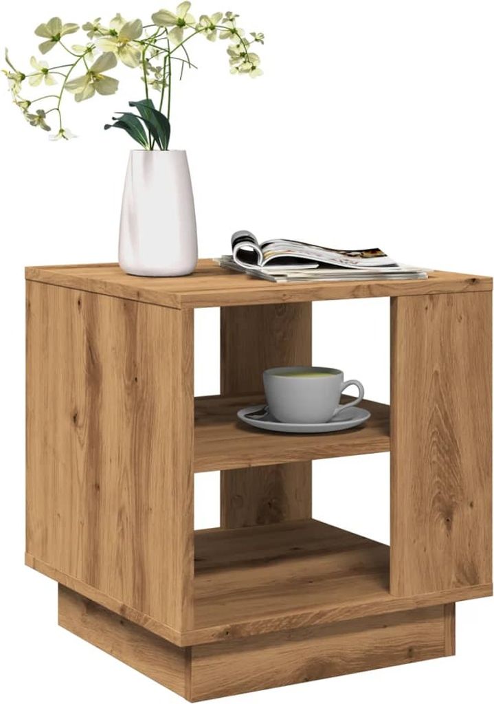 A wooden side table with a vase of flowers and a cup of coffee on it.