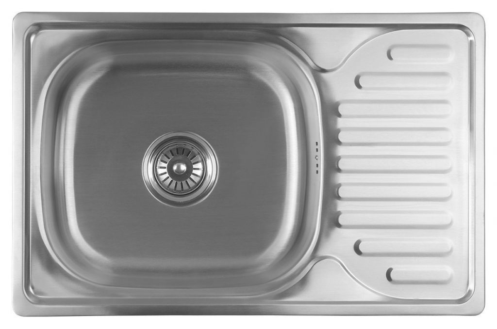 A top-down view of a stainless steel kitchen sink with a drainboard.