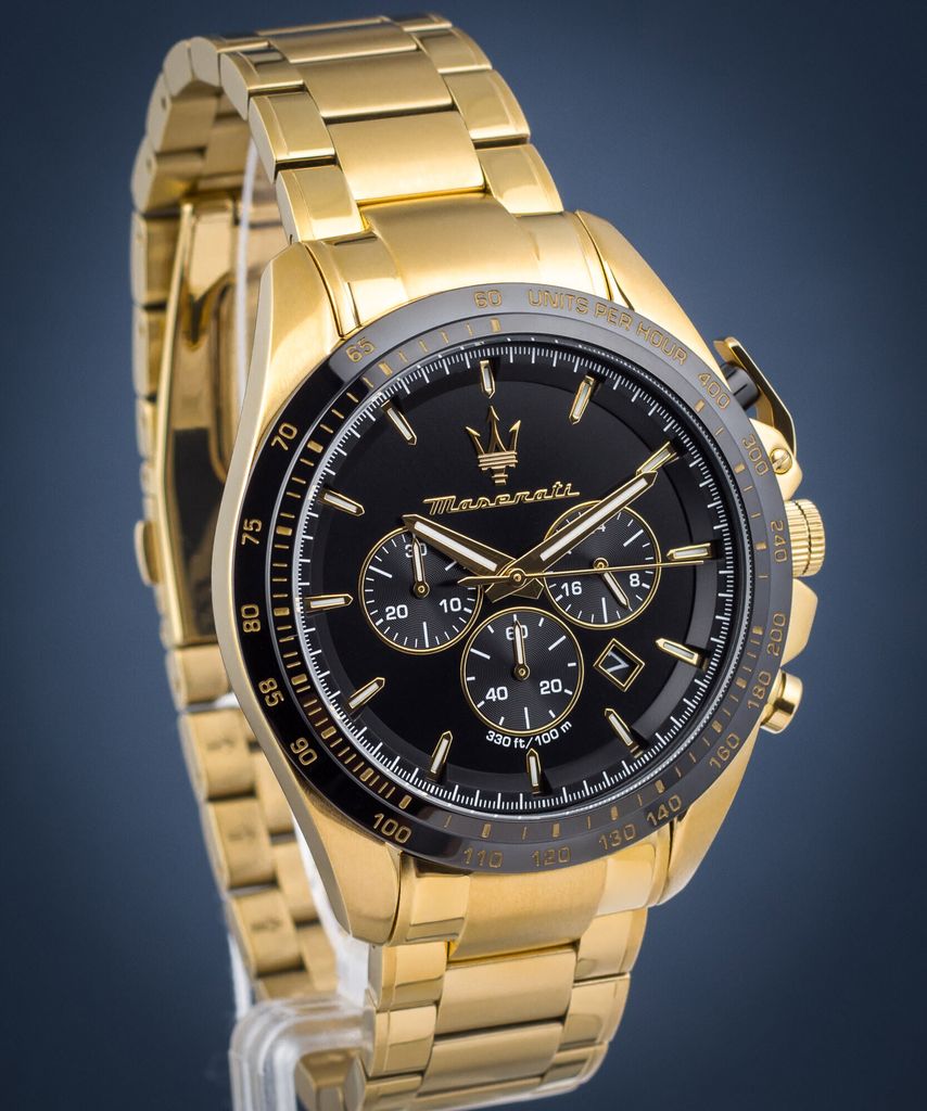 A close-up studio shot of a gold Maserati watch with a black face.