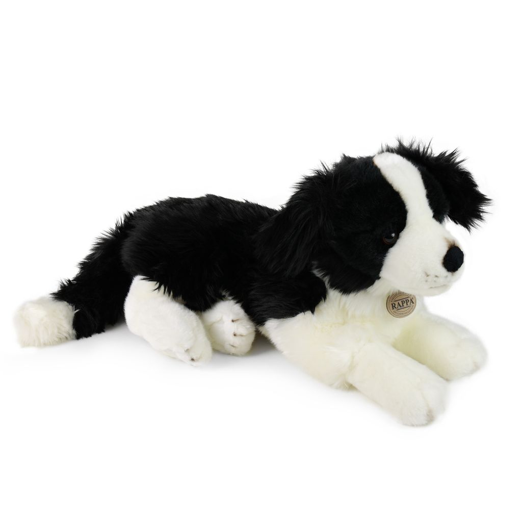 A plush toy dog lying down on a white background.