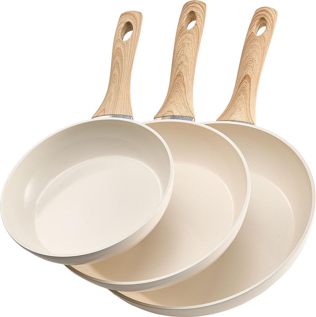 Three beige frying pans with wooden handles are arranged in a staggered formation against a white background.
