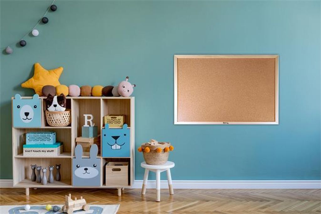 A child's room with toys and a corkboard.