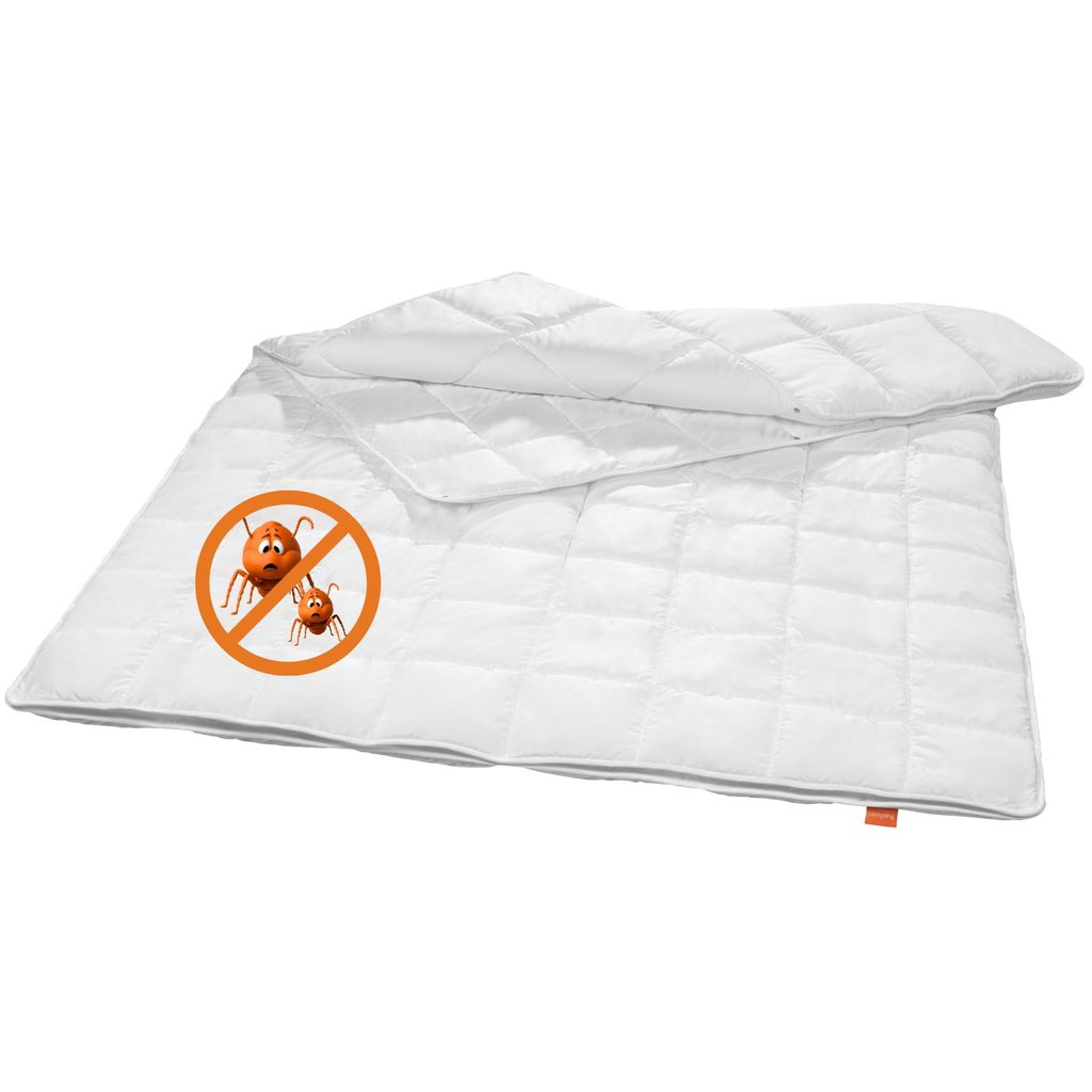 A white quilted blanket with a graphic indicating it is mite-free.