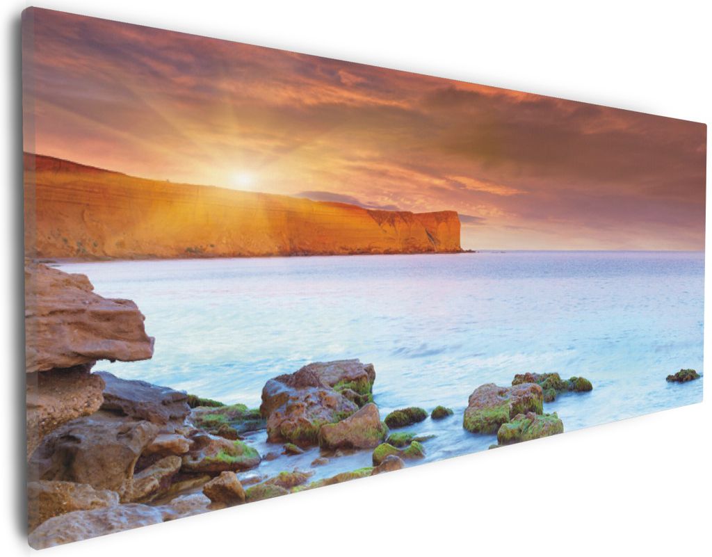 Wallario Premium Leinwandbild Sonnenaufgang am Meer mit Landzunge und Felsen im Wasser in Größe 30 x 75 cm