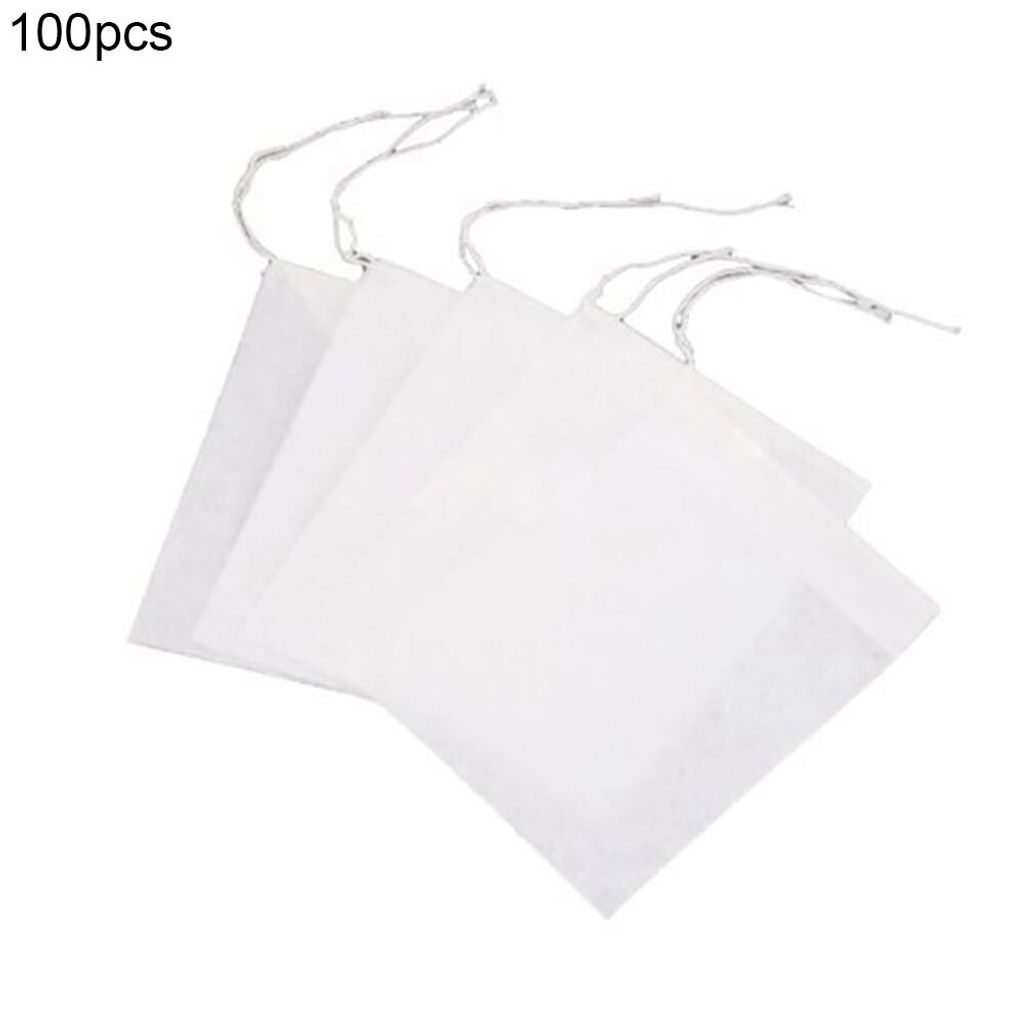 A stack of white, square filter bags with drawstrings, on a white background.