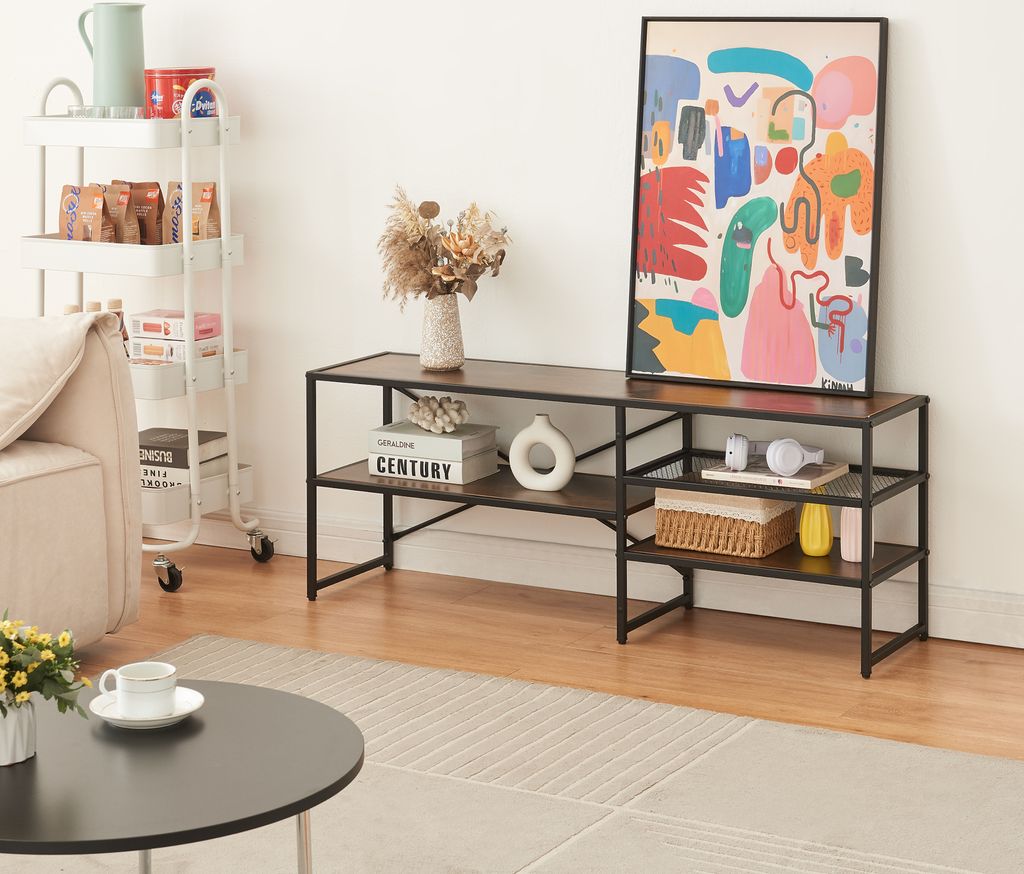A living room scene featuring a TV stand with decorative items and artwork.