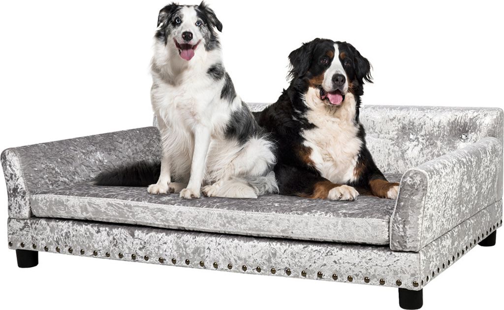 Two dogs sitting on a silver pet sofa.