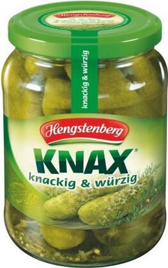 A jar of pickles on a plain background.