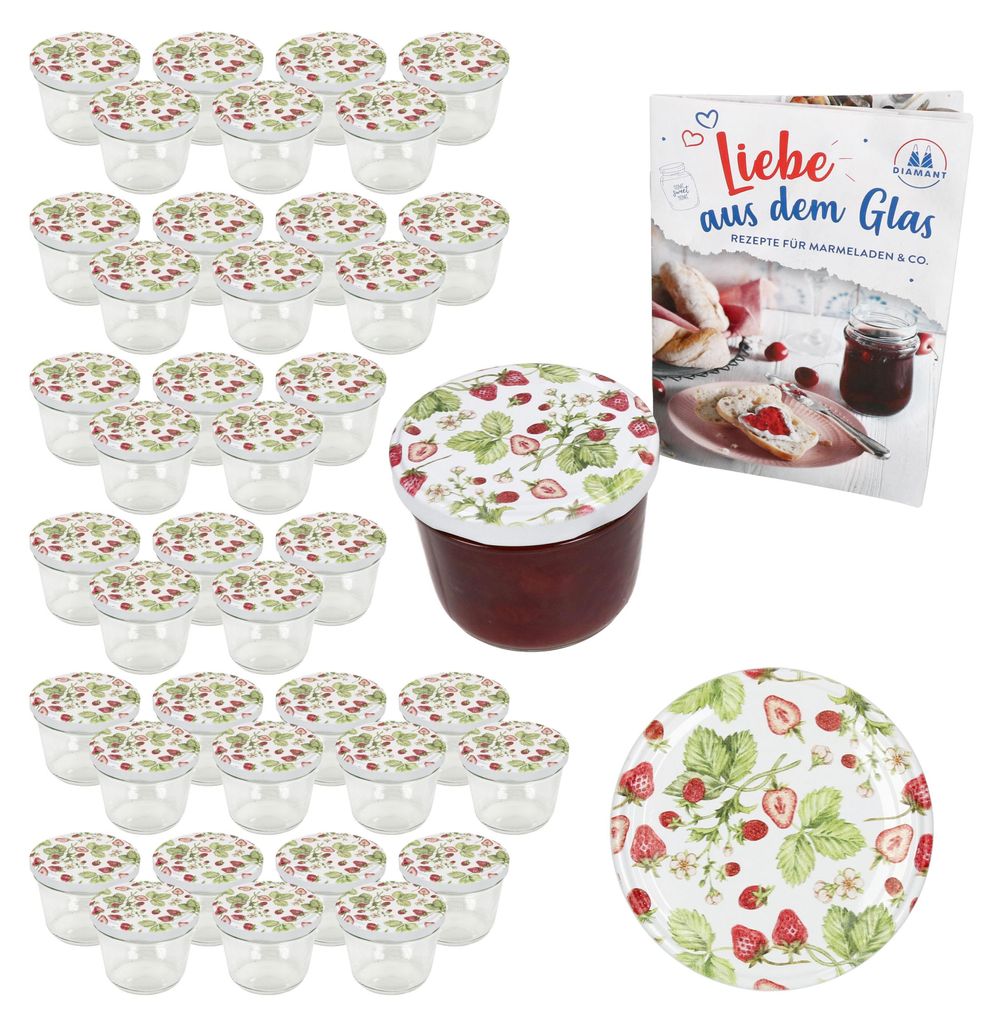 A collection of small glass jars with strawberry-themed lids, a single jar filled with jam, a recipe book, and a decorative plate, all arranged on a white background.