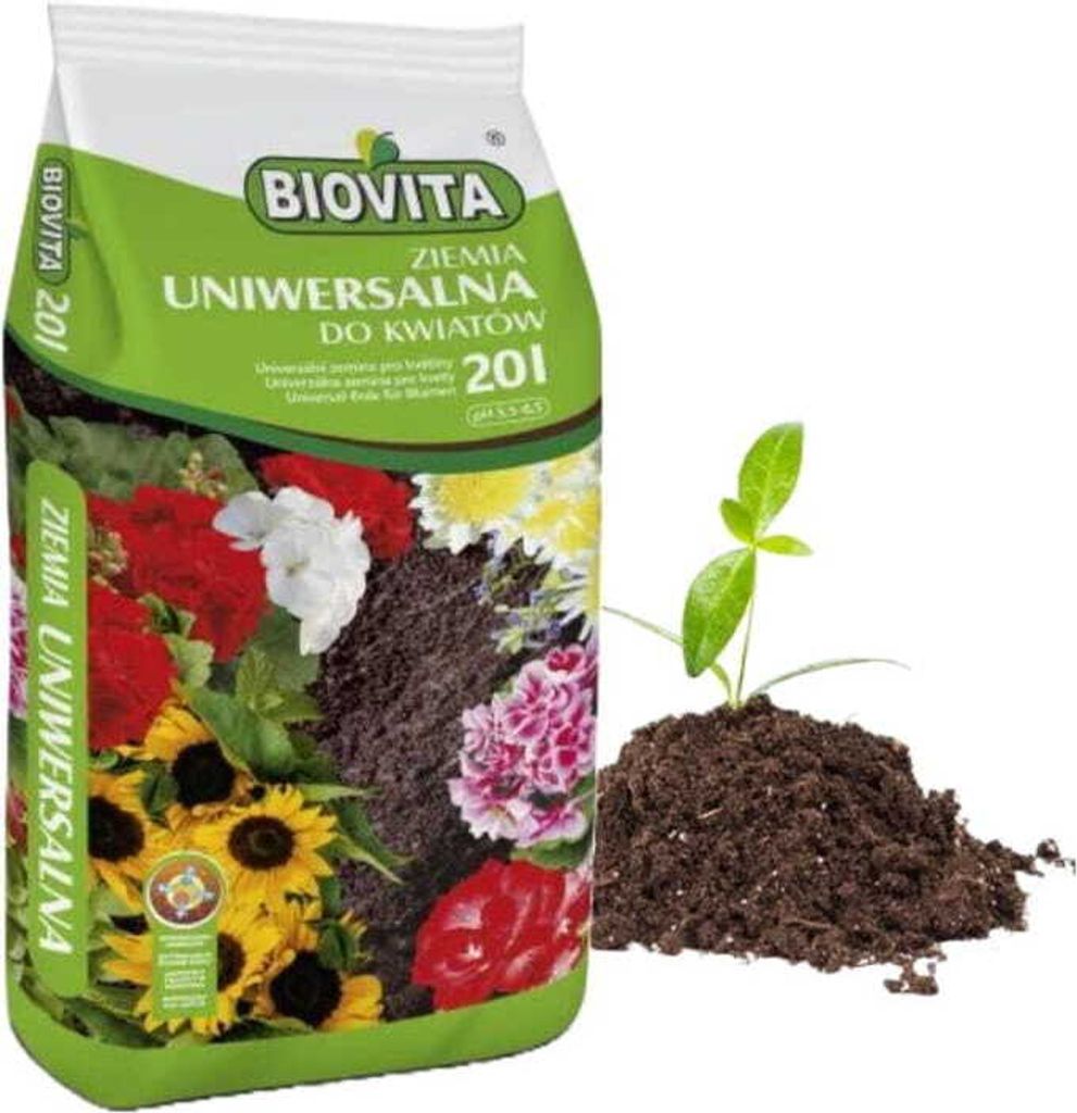 A bag of soil for flowers with a small plant growing out of a pile of soil next to it.