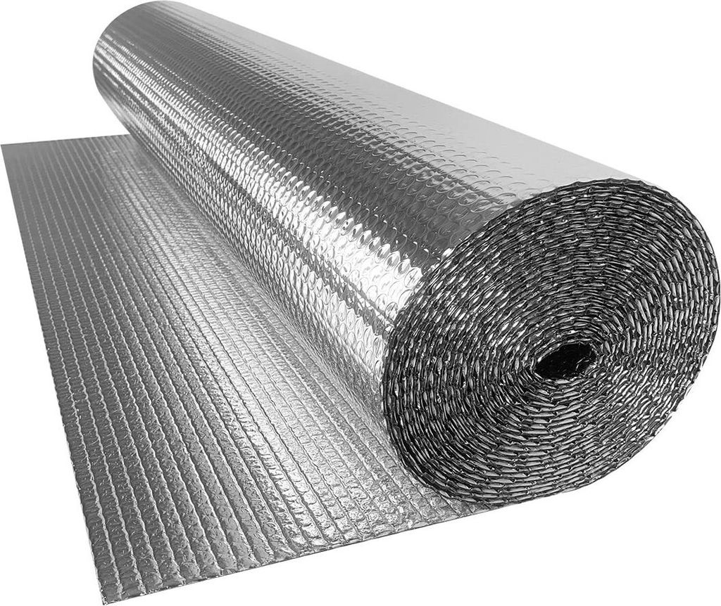 A roll of silver insulation foil is partially unrolled on a flat surface.