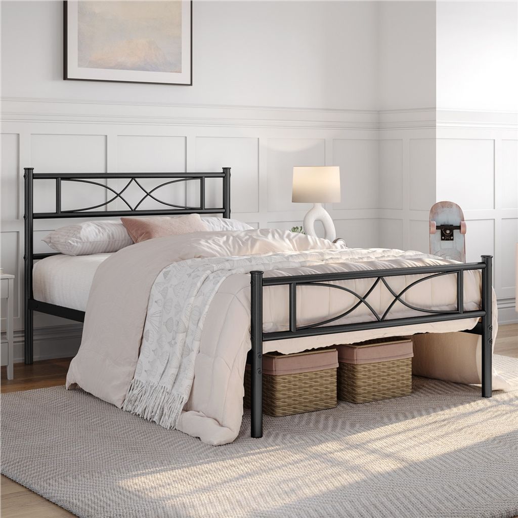 A black metal bed frame with a patterned headboard is shown in a bedroom setting.