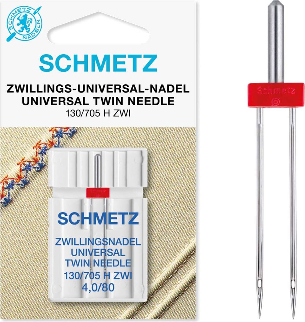 A package of Schmetz twin sewing needles and the needles themselves are displayed against a light brown fabric background.
