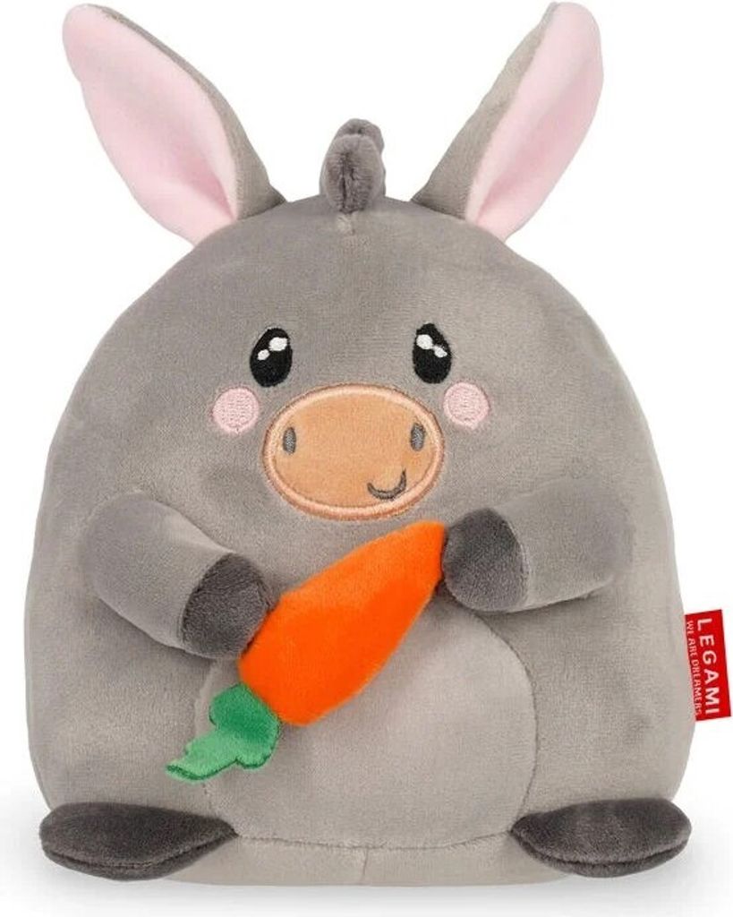 A plush toy donkey holding a carrot.
