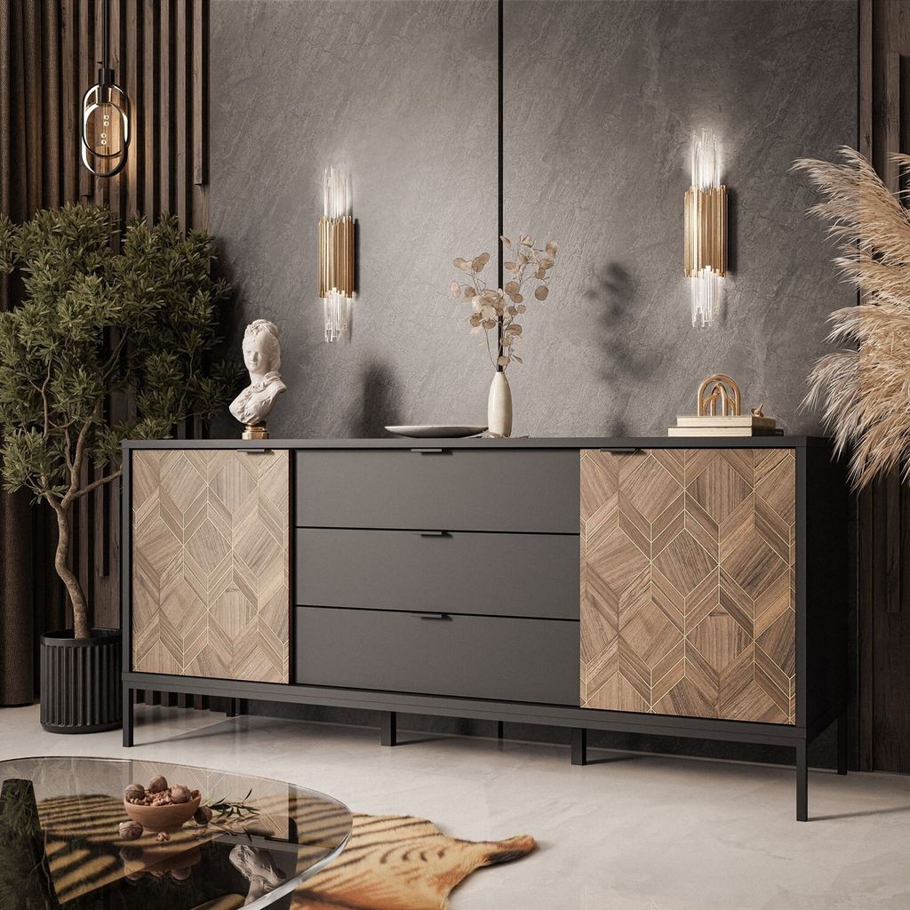 A modern living room with a sideboard, plant, and decorative items.