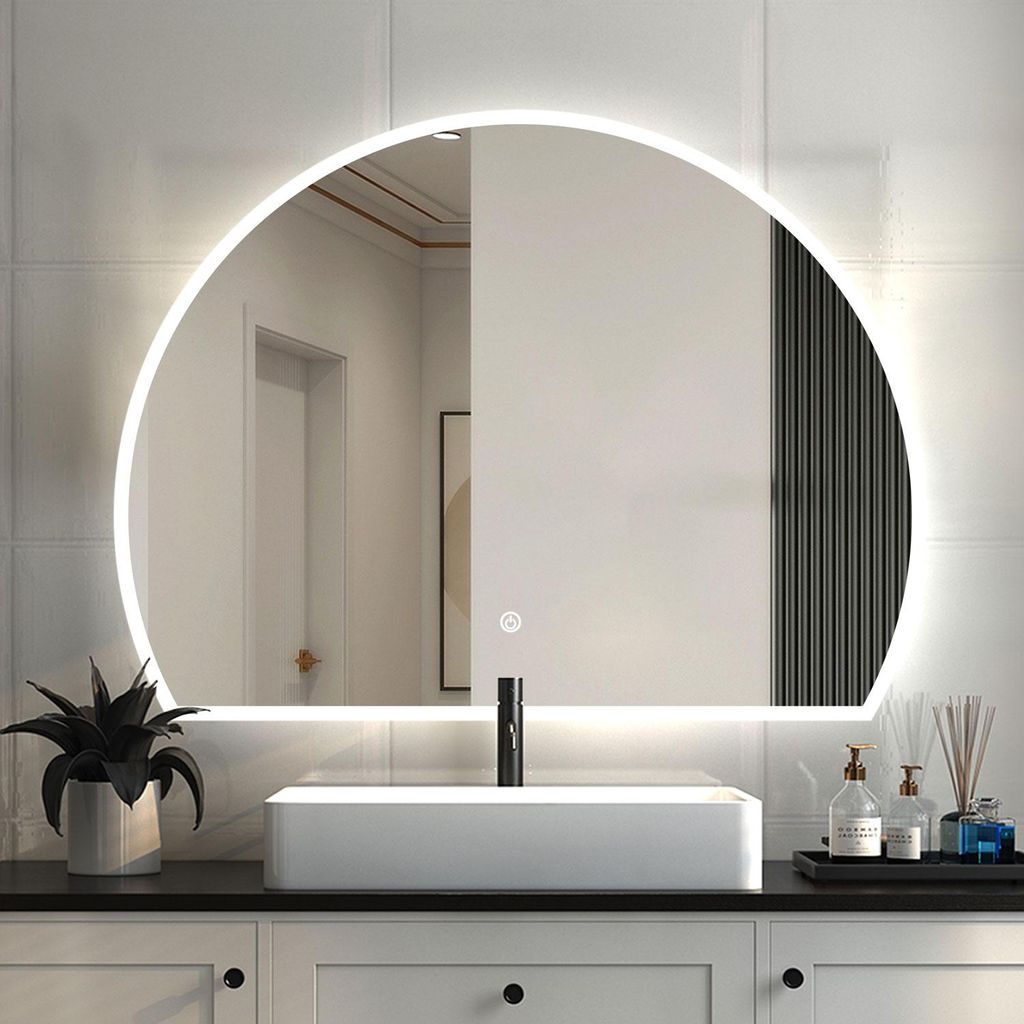 A bathroom vanity with a sink and a large illuminated mirror.