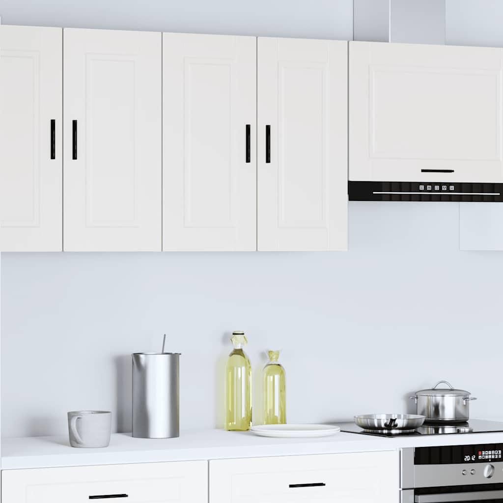 A clean, modern kitchen scene with white cabinets and appliances.