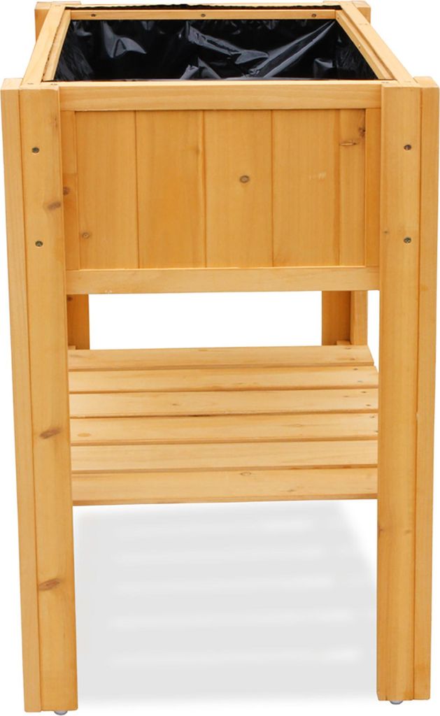 A wooden raised garden bed with a black liner inside.
