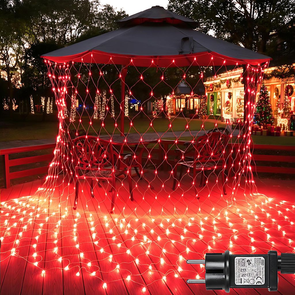 Red net lights are draped over a gazebo and spread across a wooden deck, with a house decorated for Christmas in the background.