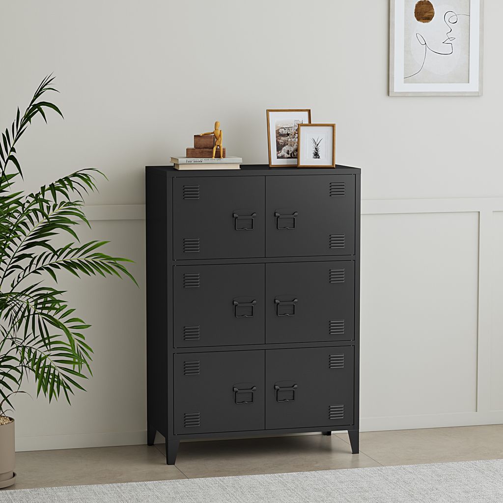 A black metal cabinet with six doors is shown in a room with a plant and framed pictures on top.