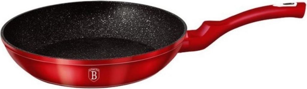 A red frying pan with a black speckled interior and a red handle, shown from a slightly elevated side angle against a white background.