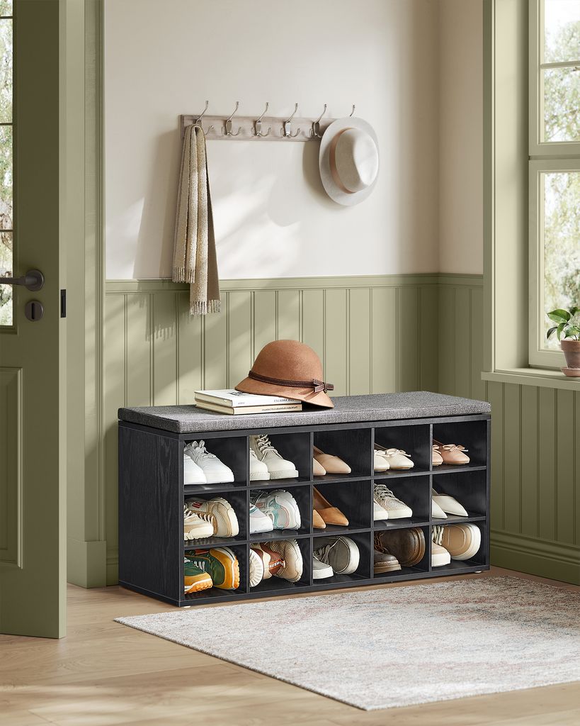 An entryway with a shoe bench, coat rack, and hat.