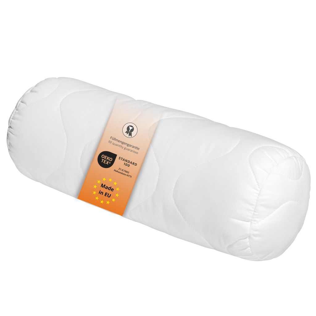 A white bolster pillow with a label attached.