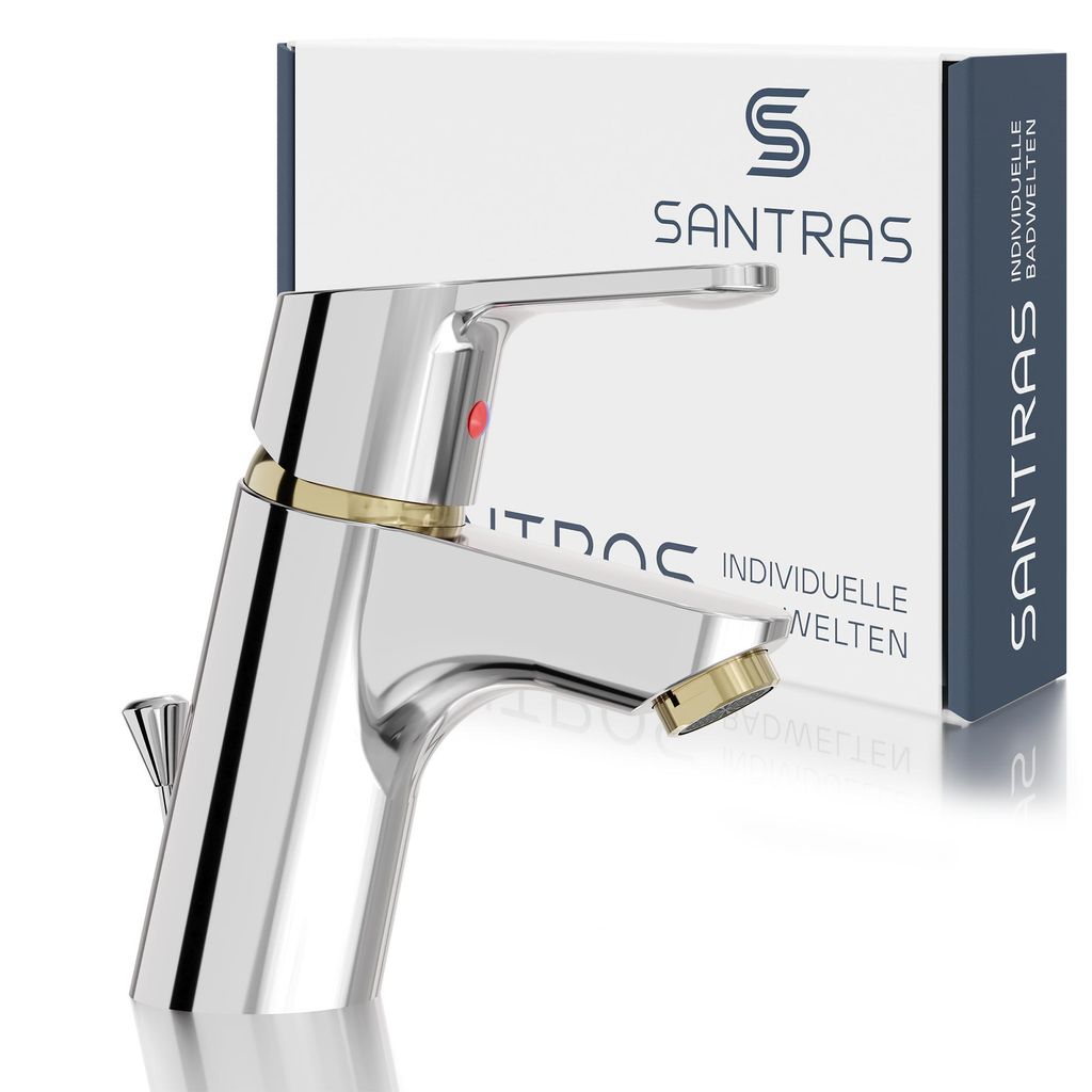 A chrome and gold faucet is shown in front of its packaging.