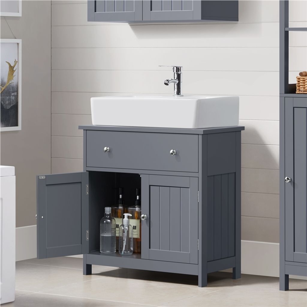 A bathroom vanity with a sink and faucet.
