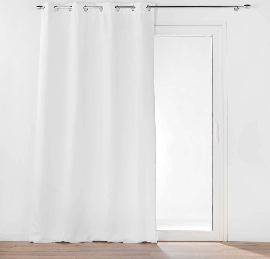 A white curtain hangs in front of a glass door, with a dark curtain rod above.
