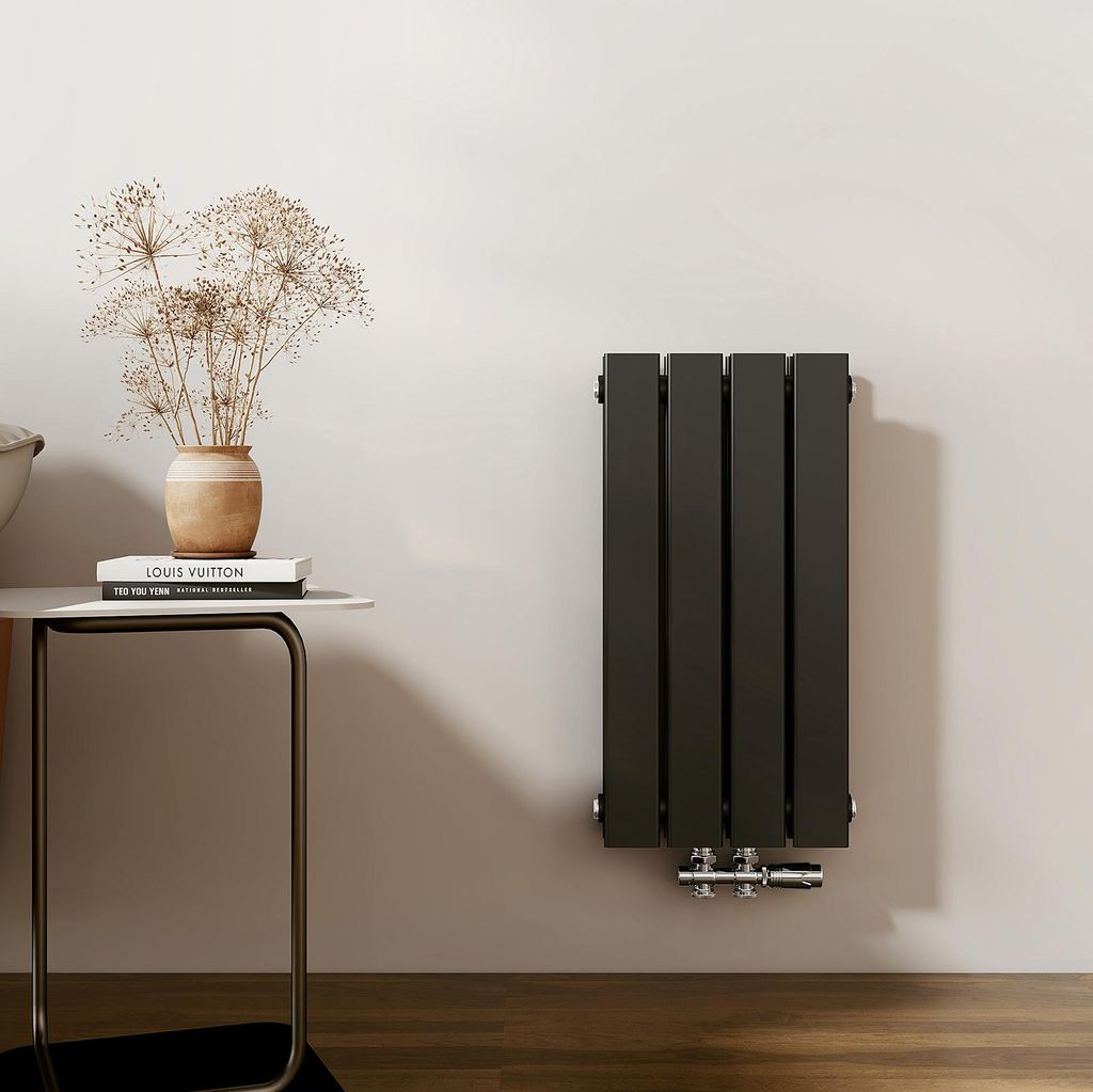 A modern bathroom or living space with a radiator mounted on the wall next to a small side table with decorative items.