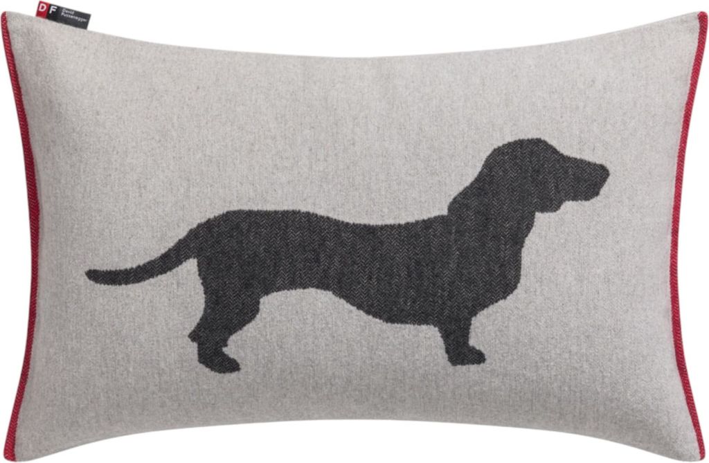 A rectangular pillow with a dachshund silhouette printed on it.