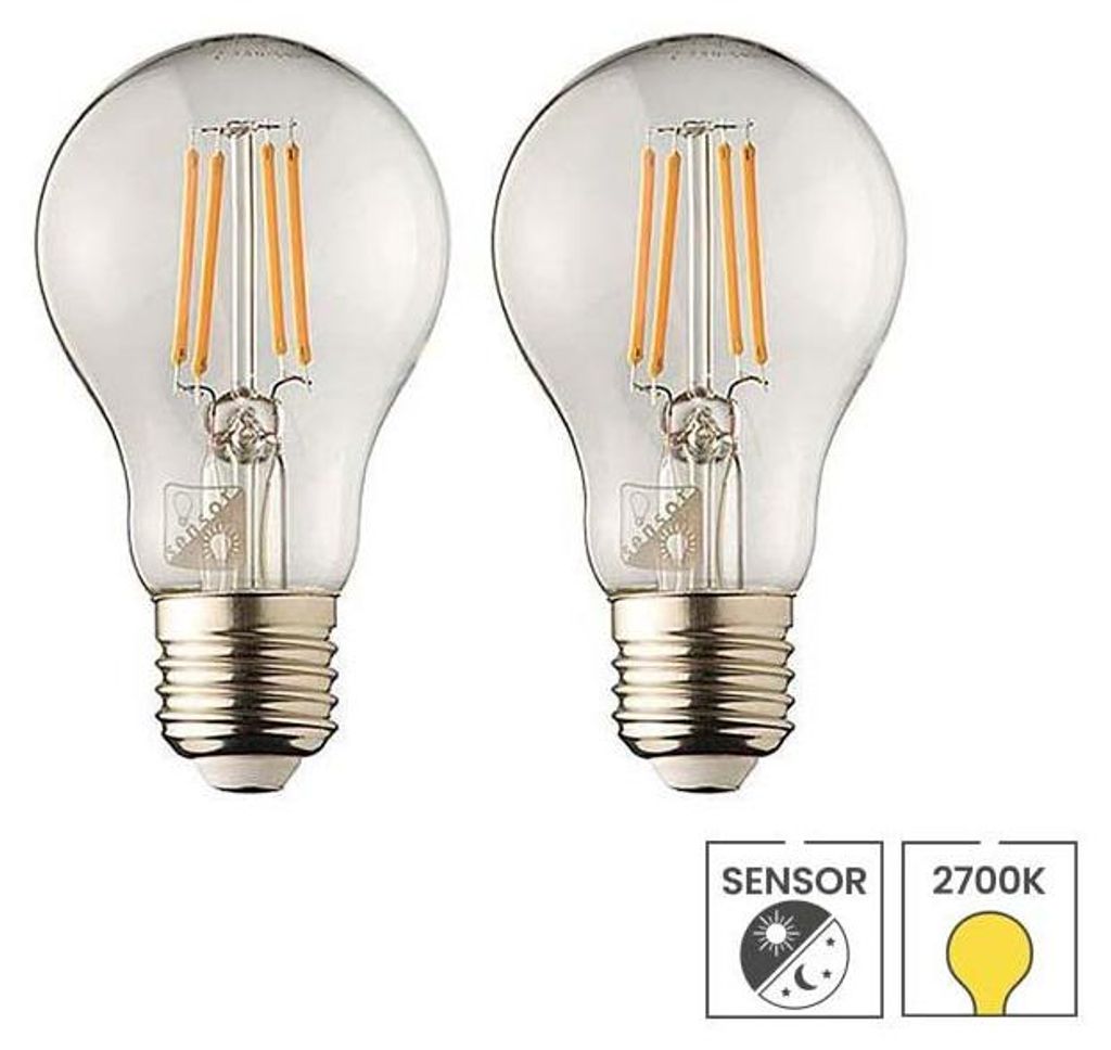 Two clear glass LED light bulbs with filament elements are shown side-by-side against a white background. Below the bulbs are two icons, one indicating a sensor and the other a color temperature.