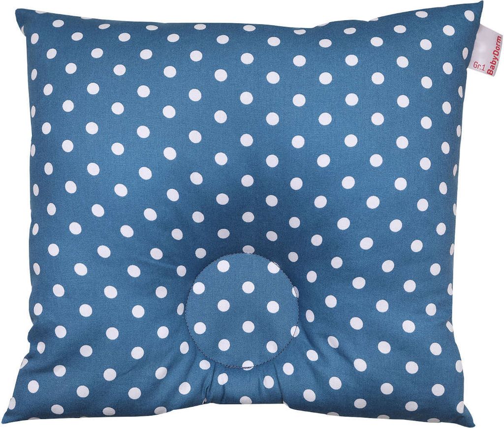 A blue polka dot baby pillow with a central indentation.