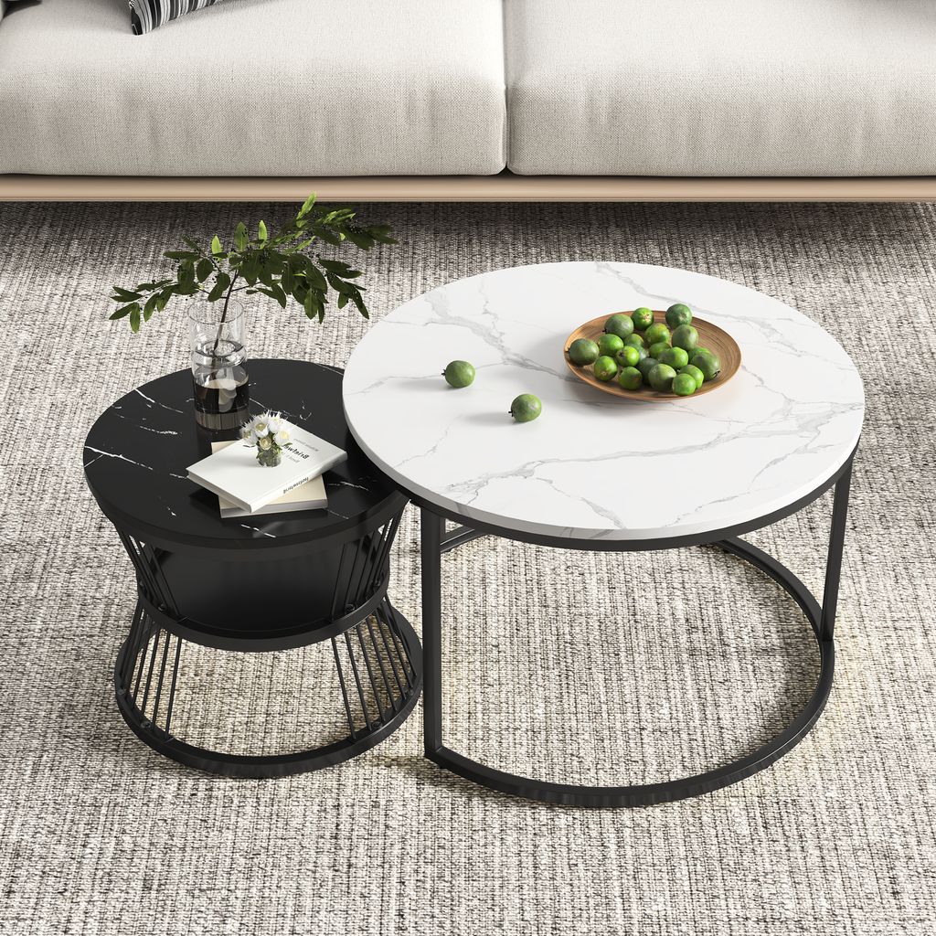 Two round coffee tables with marble patterns are placed on a rug in front of a sofa.