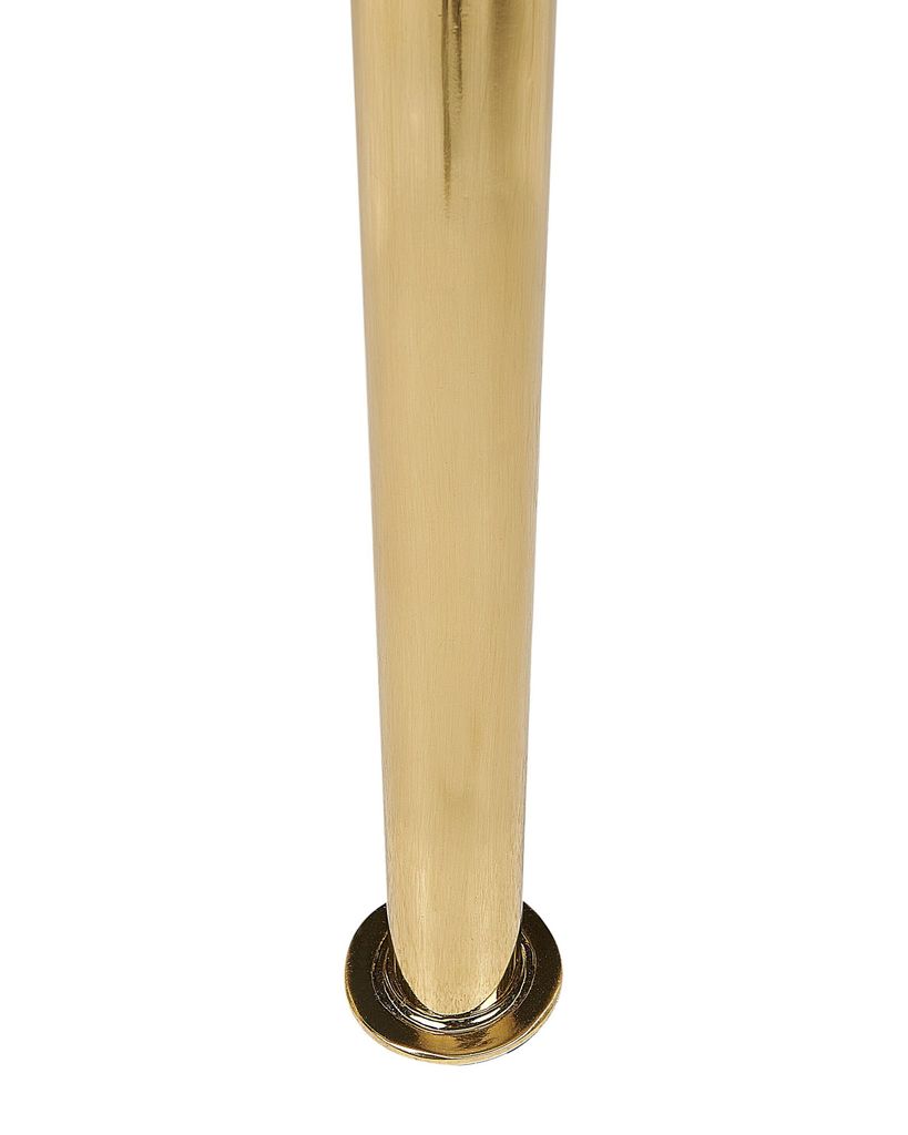 A close-up of a golden metal leg of a chair or table.